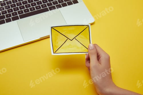 Preview: cropped image of woman holding message sign near laptop