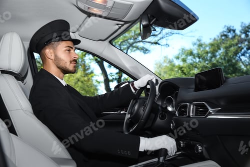 Preview: Young handsome driver in luxury car. Chauffeur service