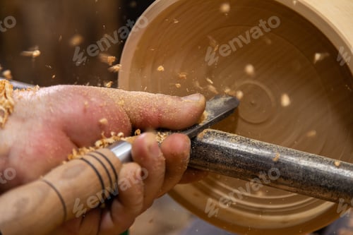 Preview: Closeup of carpenter turning wood on a lathe