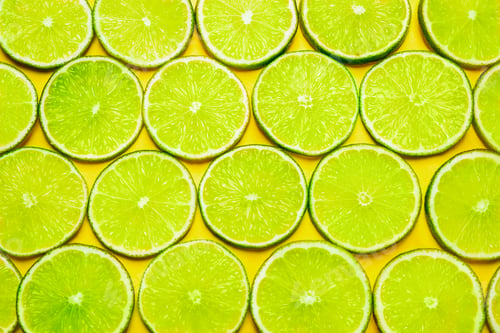 Preview: Juicy fresh lime slices on yellow background, flat lay