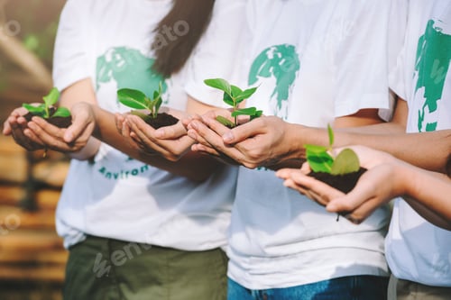 Preview: Group of diverse people volunteer conservation teamwork holding small plants