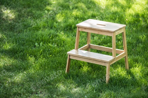 Preview: close up view of wooden stairs standing on green grass