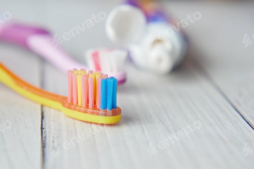 Preview: child tooth brush and paste on wooden table