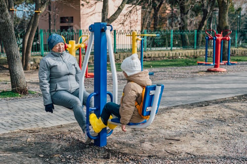 Preview: grandmother and granddaughter go in for sports on simulators outdoors to maintain health, cohesion