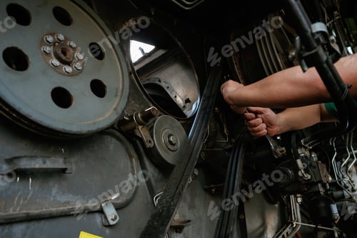 Preview: Mechanic working on industrial machinery in a workshop