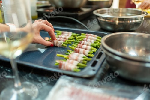 Preview: Woman hands arranging appetizers on restaurant kitchen. Bacon and green beans pods