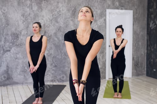 Preview: Young sportive trio group of girls are practicing yoga exercises in the studio