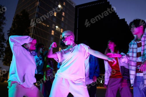Preview: Drive in motion. Stylish people dancing hip-hop in bright clothes on city background at dance hall