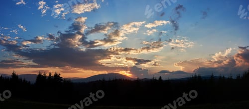 Preview: Serene evening sky with hues of blue and soft pink clouds as sun sets.