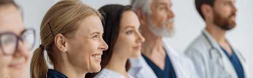 Preview: Group of professional doctors standing in a line at the modern clinic