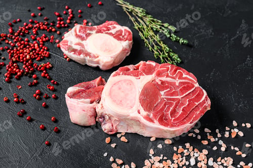 Preview: Raw fresh ossobuco con with herbs. osso buco meat. Black background. Top view