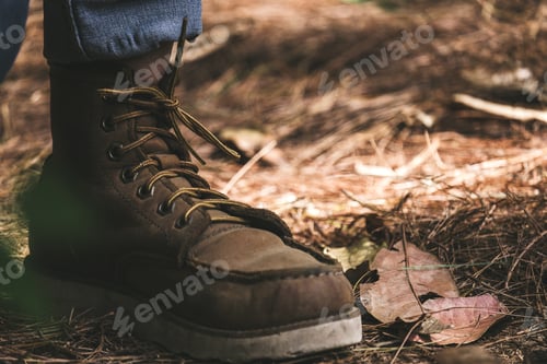 Preview: a man wearing boots while trekking in a tropical forest