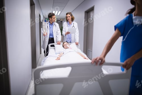 Preview: Doctors pushing emergency stretcher bed in corridor