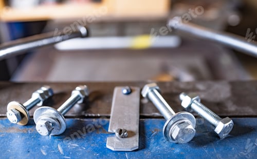 Preview: Metal chrome bolts and nuts on manual flexible massive machine