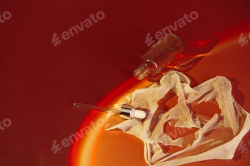 Preview: Cosmetic face mask with serum and dropper under hard red light