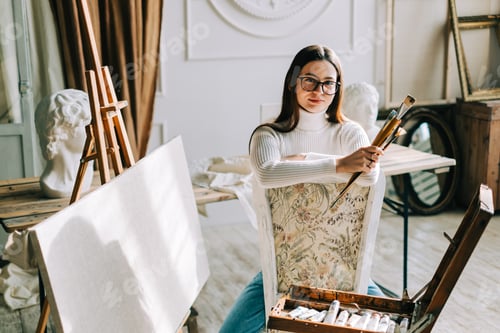 Preview: Young Woman with Painting Brushes in Studio