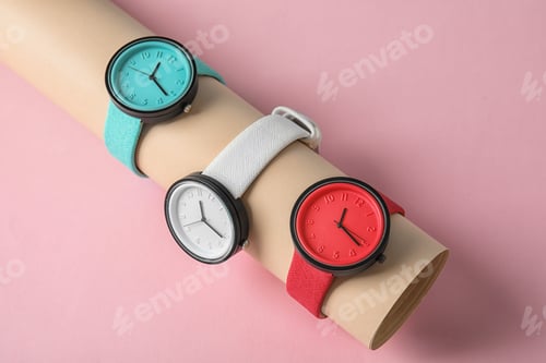 Preview: Holder with collection of stylish wrist watches on color background. Fashion accessory