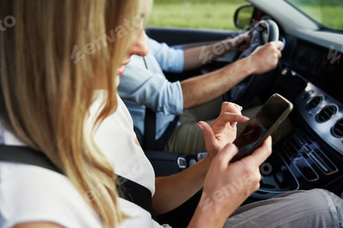 Preview: Caucasian of middle age woman using mobile phone during a car trip