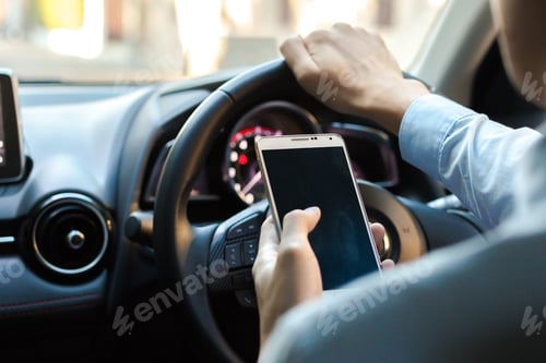 Preview: man using phone while driving the car (selective focus) - transportation and vehicle concept