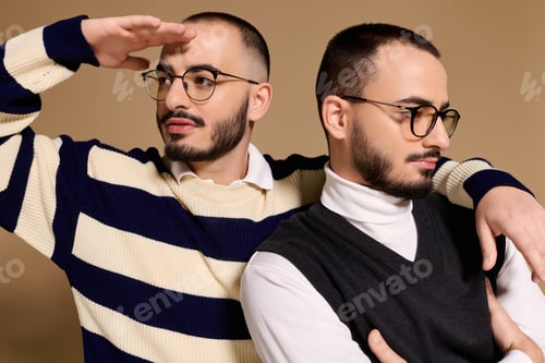 Preview: Stylish twins pose confidently with unique expressions and fashionable outfits in a warm setting