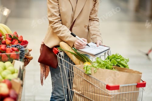 Preview: Woman Pushing Shopping Cart in Supermarket