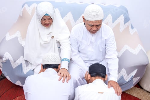 Preview: Rear view of two son kneeling to ask forgiveness to parents