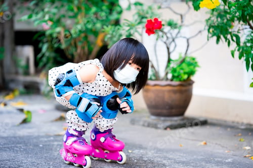 Preview: Cute little girl playing pink skate. First play extreme sports for child.