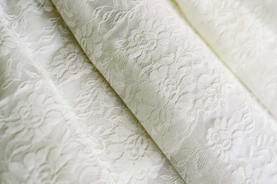 Cover for detail of the texture of the luxurious white fabric of a wedding dress
