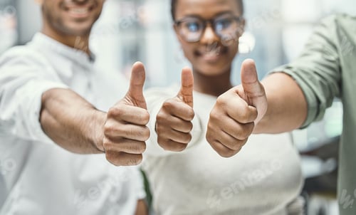 Preview: Shot of three businesspeople showing thumbs up while standing together