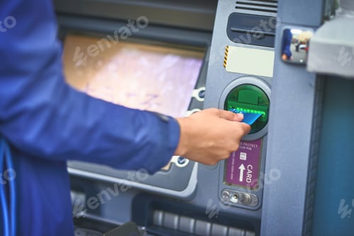 Preview: Card in, cash out. Cropped shot of a woman making a transaction with her bank card at an ATM.