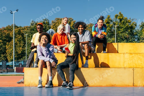 Preview: Multiracial group of young friends bonding outdoors