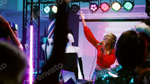 Preview: Young woman working as DJ at party