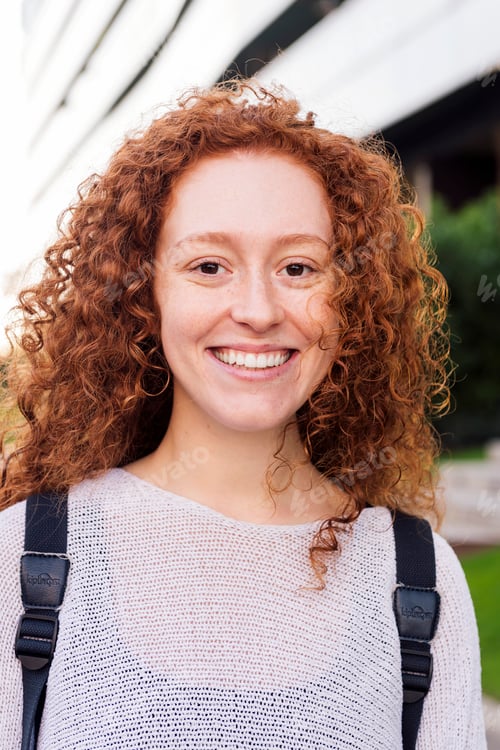 Preview: portrait of a happy young woman with curly hair