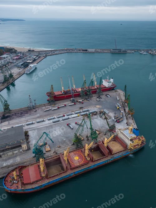 Preview: Aerial view of big cargo ship bulk carrier is loaded with grain of wheat in port