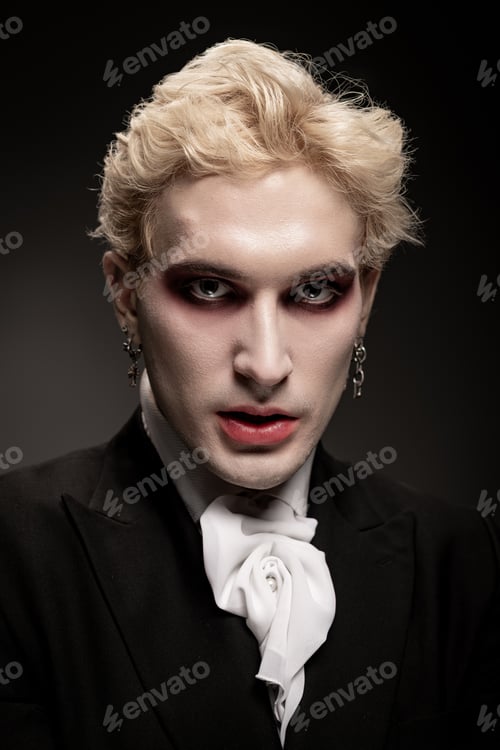 Preview: Young handsome man showcases an epic Halloween costume with dramatic makeup and flair
