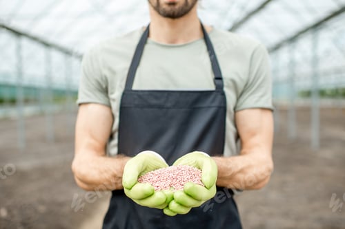 Preview: Farmer holding mineral fertilizers