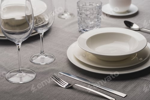 Preview: Serving dinnerware with cutlery and glasses on grey linen tablecloth
