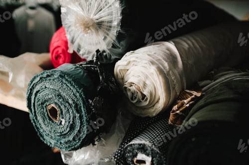 Preview: Fabric rolls stacked on shelf, ready for cutting, sewing, and garment production.