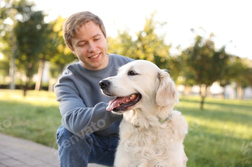 Preview: Man with his adorable golden retriever dog in park