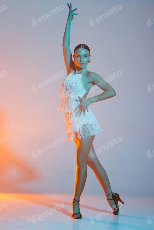 Preview: Elegant dancer in fringed dress dancing solo salsa dance showing dramatic