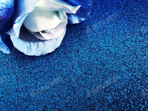 Preview: Blue rose on blue glitter background with space for copy