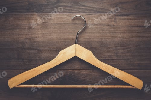 Preview: Wooden Hanger on a Brown Wood Background