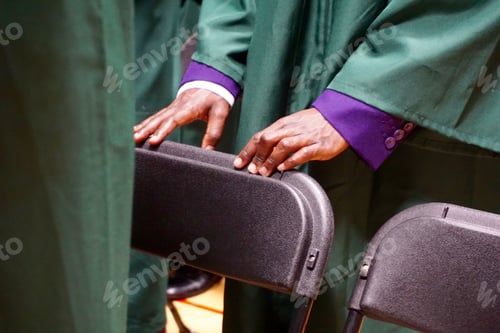 Preview: Hands resting on chair at graduation