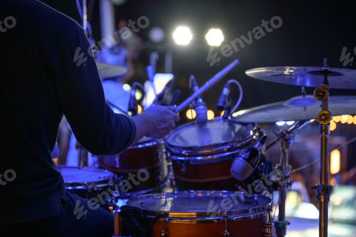 Preview: Drummer is playing the drums on stage at event