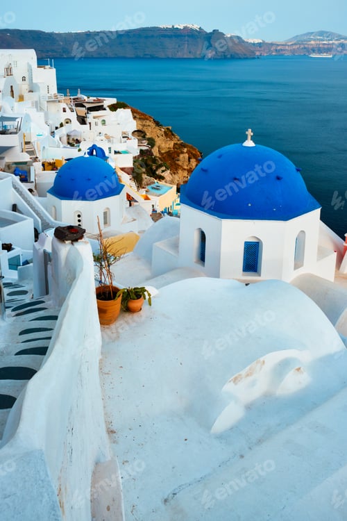 Preview: Famous view from viewpoint of Santorini Oia village with blue dome of greek orthodox Christian