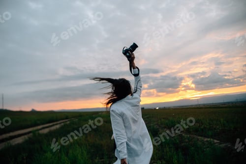 Preview: Sunset and girl photographer