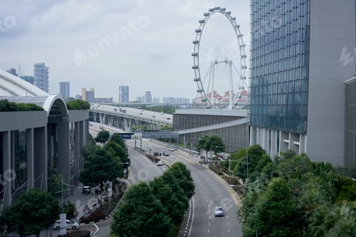 Preview: Urban landscape with a giant Ferris wheel overlooking a bustling city street and modern buildings.