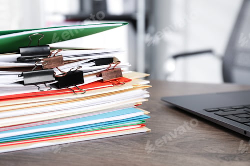 Preview: Many folders with documents and laptop on wooden desk, closeup
