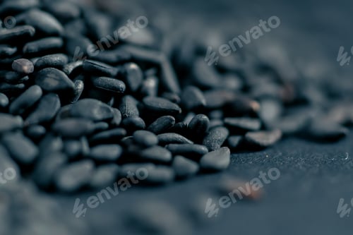 Preview: close-up of black sesame seeds lying on blue-black background salad dressing healthy seeds protein