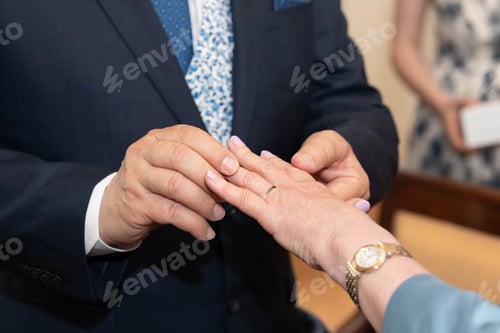 Preview: The groom puts a ring on the bride's finger